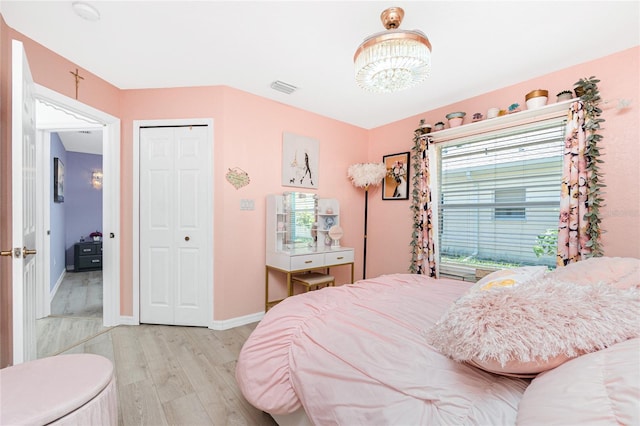 926 Boundary Blvd, Rotonda West, FL 33947 - bedroom featuring light wood-style flooring, a chandelier, and a closet