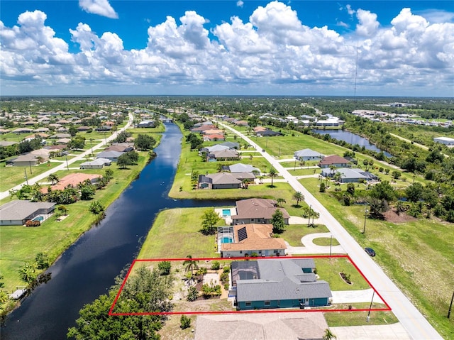 926 Boundary Blvd, Rotonda West, FL 33947 - aerial perspective of suburban area with a large body of water and property parcel outlined