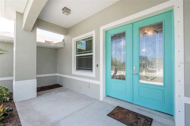 6 Medalist Ct, Rotonda West, FL 33947 - view of exterior entry featuring french doors and stucco siding