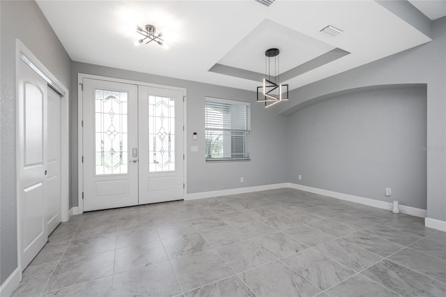 6 Medalist Ct, Rotonda West, FL 33947 - foyer with a chandelier, french doors, light marble finish flooring, and a tray ceiling