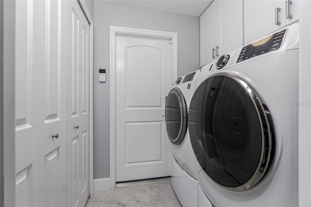 6 Medalist Ct, Rotonda West, FL 33947 - washroom with cabinet space, washer and clothes dryer, and light marble finish flooring