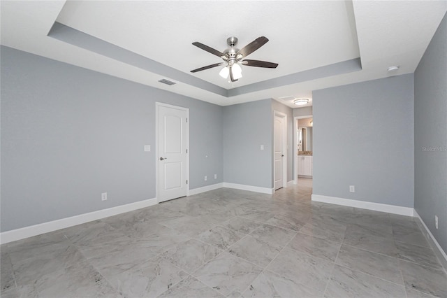 6 Medalist Ct, Rotonda West, FL 33947 - empty room featuring a tray ceiling, a ceiling fan, and a smoke detector