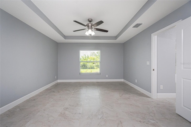 6 Medalist Ct, Rotonda West, FL 33947 - spare room featuring a raised ceiling, ceiling fan, and light marble finish floors