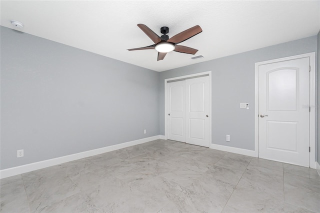 6 Medalist Ct, Rotonda West, FL 33947 - unfurnished bedroom featuring light marble finish flooring, a closet, and ceiling fan