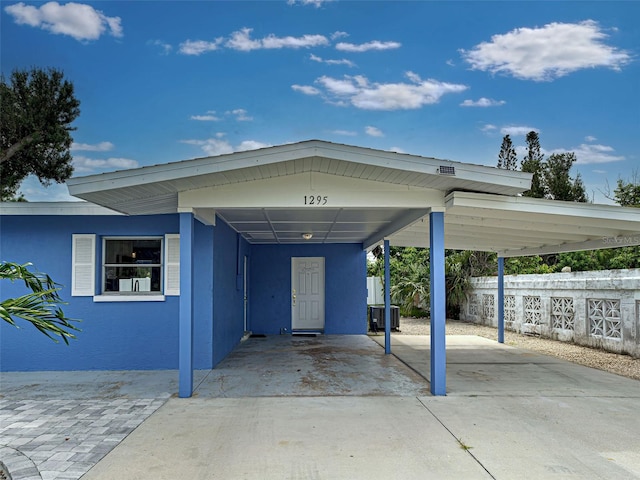 1295 S Maryknoll Rd, Englewood, FL 34223 - view of exterior entry featuring a carport and driveway