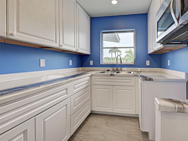 1295 S Maryknoll Rd, Englewood, FL 34223 - kitchen featuring stainless steel microwave, white cabinets, light countertops, and recessed lighting