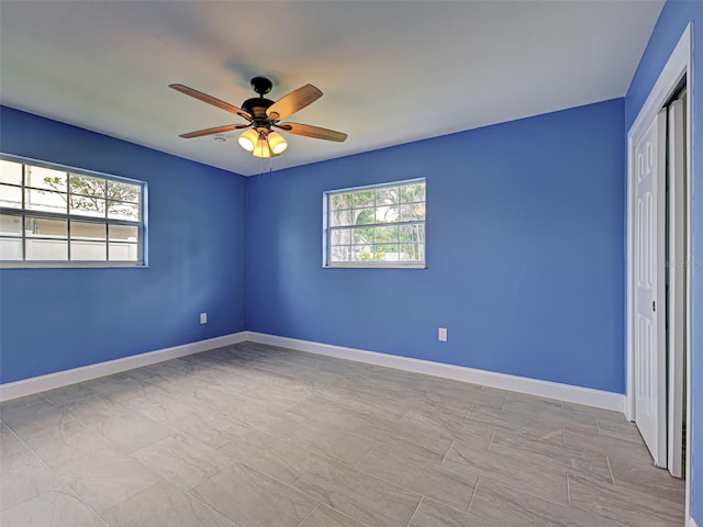 1295 S Maryknoll Rd, Englewood, FL 34223 - empty room with a ceiling fan and baseboards