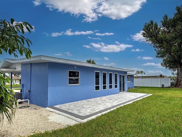 1295 S Maryknoll Rd, Englewood, FL 34223 - back of house with a patio area and stucco siding