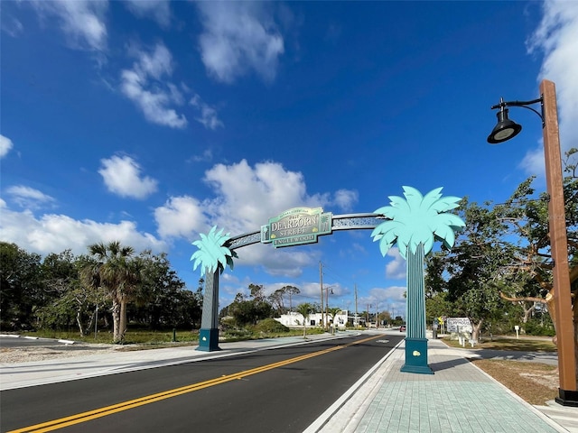 1295 S Maryknoll Rd, Englewood, FL 34223 - view of asphalt street featuring sidewalks, street lights, and curbs