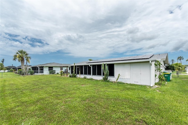 39 Caddy Rd, Rotonda West, FL 33947 - back of house with solar panels, a fenced backyard, and a sunroom