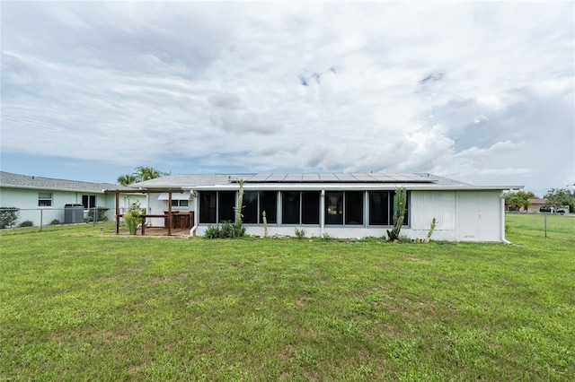 39 Caddy Rd, Rotonda West, FL 33947 - rear view of property with a sunroom and solar panels