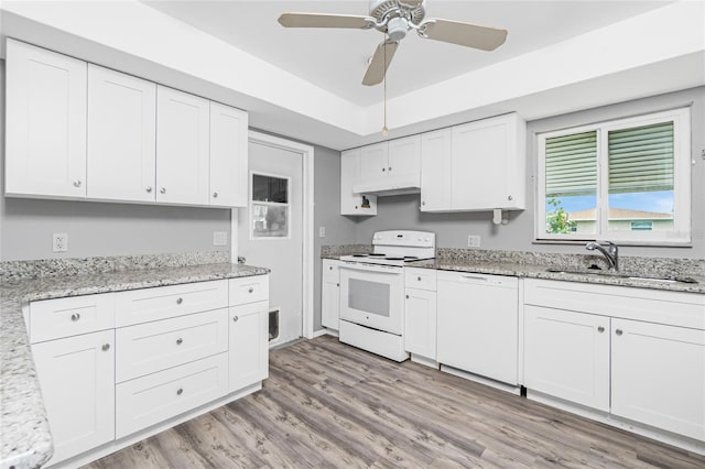 39 Caddy Rd, Rotonda West, FL 33947 - kitchen featuring white appliances, white cabinets, a ceiling fan, light wood-style flooring, and light stone countertops