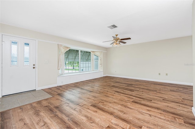 39 Caddy Rd, Rotonda West, FL 33947 - entrance foyer with wood finished floors and ceiling fan