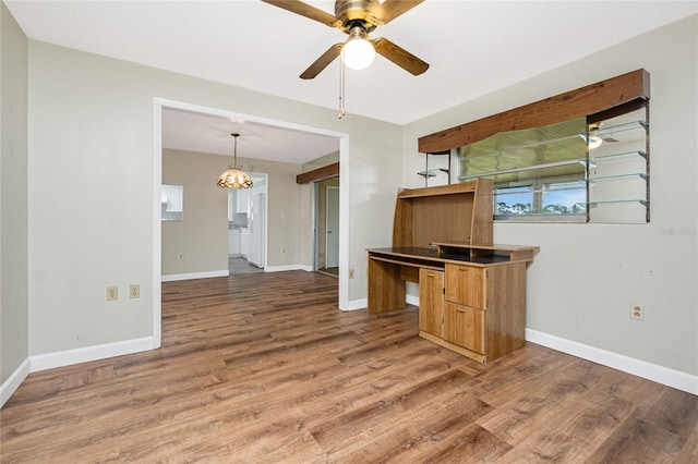 39 Caddy Rd, Rotonda West, FL 33947 - unfurnished living room featuring light wood-style floors, ceiling fan, and a chandelier