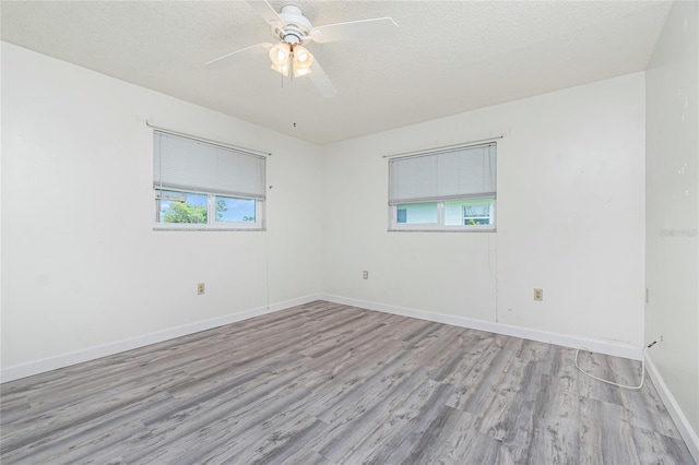 39 Caddy Rd, Rotonda West, FL 33947 - spare room featuring wood finished floors, a ceiling fan, and a textured ceiling