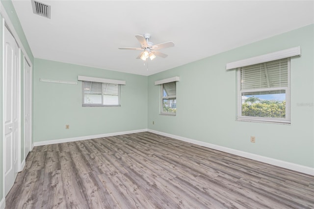 39 Caddy Rd, Rotonda West, FL 33947 - unfurnished bedroom with wood finished floors and a ceiling fan
