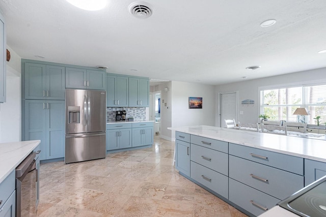 1030 Haste Ln, Englewood, FL 34223 - kitchen featuring stainless steel appliances, light stone counters, tasteful backsplash, and recessed lighting