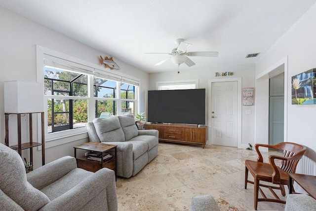 1030 Haste Ln, Englewood, FL 34223 - living area featuring a ceiling fan and light stone finish flooring