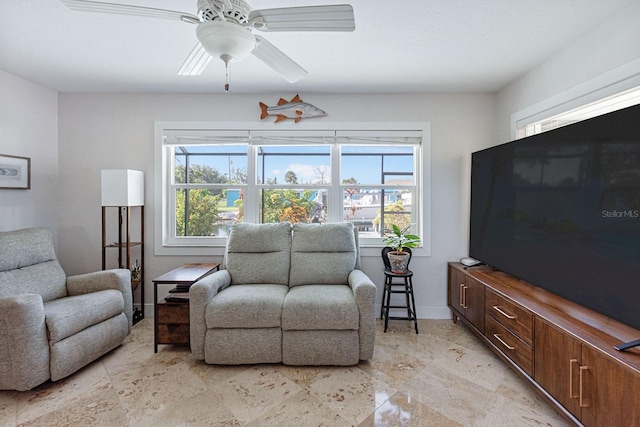 1030 Haste Ln, Englewood, FL 34223 - living room with ceiling fan and baseboards