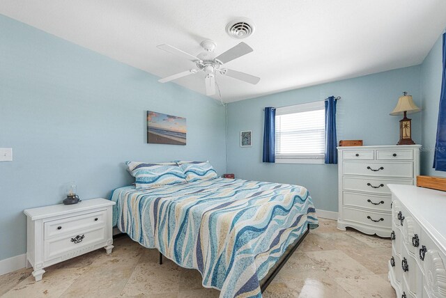 1030 Haste Ln, Englewood, FL 34223 - bedroom featuring light stone finish flooring and a ceiling fan