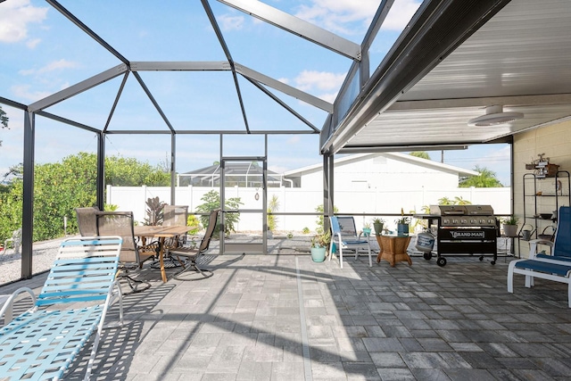 1030 Haste Ln, Englewood, FL 34223 - view of patio / terrace with outdoor dining area, area for grilling, and glass enclosure
