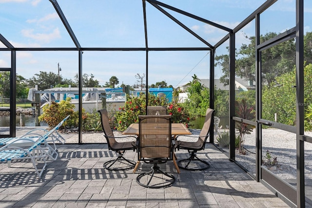 1030 Haste Ln, Englewood, FL 34223 - view of patio featuring a lanai, outdoor dining area, and a water view
