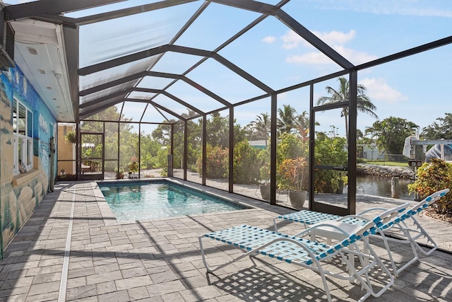 1030 Haste Ln, Englewood, FL 34223 - outdoor pool with a patio, glass enclosure, and a water view