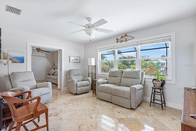 1030 Haste Ln, Englewood, FL 34223 - living area featuring a ceiling fan and baseboards