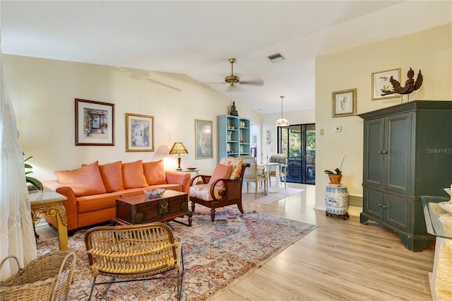 7104 Castilla St, Port Charlotte, FL 33981 - living room with vaulted ceiling, light wood-style floors, and a ceiling fan