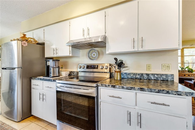 7104 Castilla St, Port Charlotte, FL 33981 - kitchen featuring extractor fan, appliances with stainless steel finishes, dark countertops, white cabinetry, and a textured ceiling