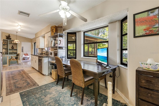 7104 Castilla St, Port Charlotte, FL 33981 - dining space featuring light tile patterned flooring, a textured ceiling, ceiling fan, and vaulted ceiling