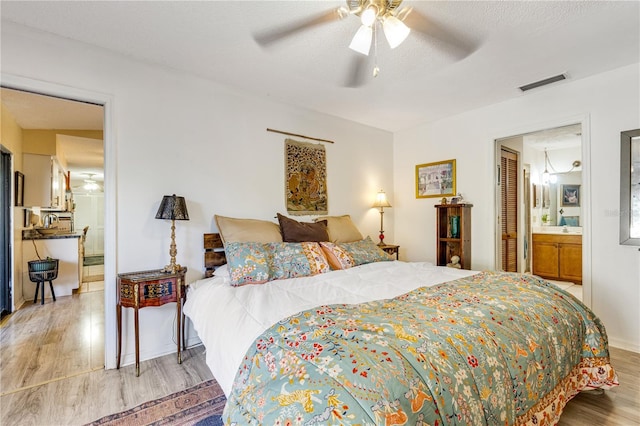 7104 Castilla St, Port Charlotte, FL 33981 - bedroom with wood finished floors, ensuite bath, and a ceiling fan
