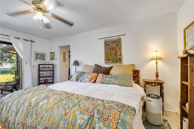 7104 Castilla St, Port Charlotte, FL 33981 - bedroom with access to exterior, a textured ceiling, wood finished floors, and a ceiling fan