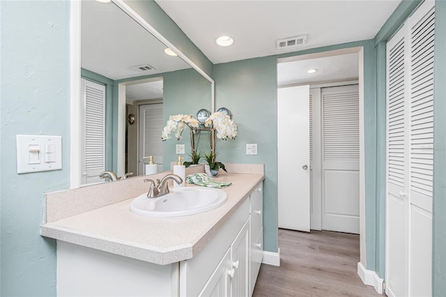 2955 N Beach Rd Unit A411, Englewood, FL 34223 - bathroom with a closet, vanity, wood finished floors, and recessed lighting