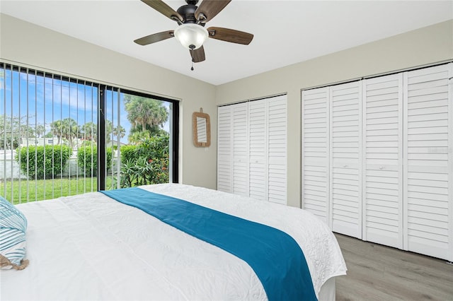 2955 N Beach Rd Unit A411, Englewood, FL 34223 - bedroom featuring two closets, wood finished floors, and a ceiling fan