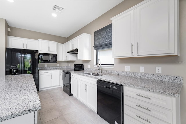 1530 Hyssop Loop, North Port, FL 34289 - kitchen with black appliances, under cabinet range hood, white cabinetry, light tile patterned floors, and recessed lighting
