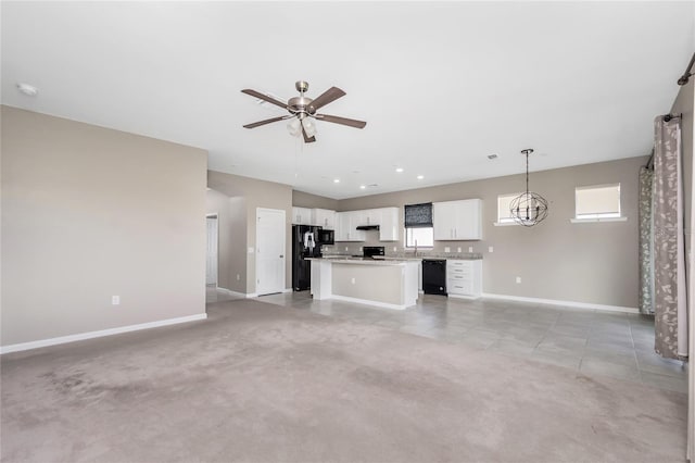 1530 Hyssop Loop, North Port, FL 34289 - unfurnished living room featuring a ceiling fan, light tile patterned floors, a chandelier, and light colored carpet