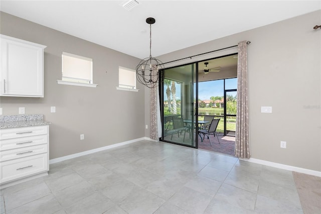 1530 Hyssop Loop, North Port, FL 34289 - unfurnished dining area featuring plenty of natural light, light tile patterned floors, and a chandelier