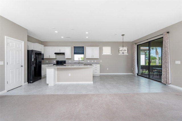 1530 Hyssop Loop, North Port, FL 34289 - kitchen featuring black appliances, light tile patterned floors, white cabinetry, a chandelier, and a center island