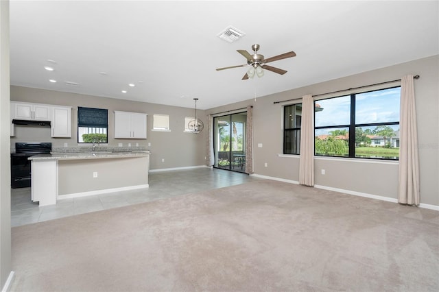 1530 Hyssop Loop, North Port, FL 34289 - unfurnished living room featuring a ceiling fan, recessed lighting, light colored carpet, and light tile patterned floors