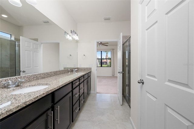 1530 Hyssop Loop, North Port, FL 34289 - full bath with double vanity, a tile shower, tile patterned floors, and ceiling fan