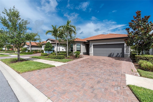 1530 Hyssop Loop, North Port, FL 34289 - view of front facade featuring an attached garage, stucco siding, decorative driveway, and a tile roof