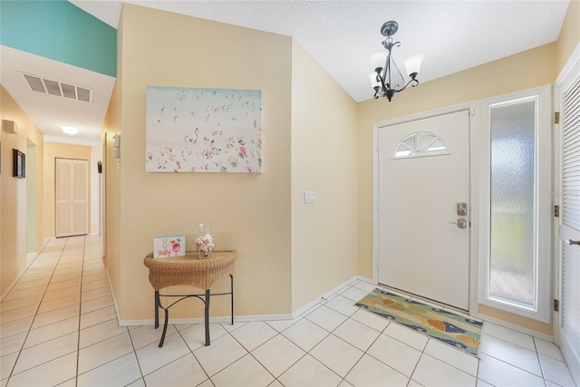 7453 Spinnaker Blvd, Englewood, FL 34224 - entryway featuring a chandelier and light tile patterned floors