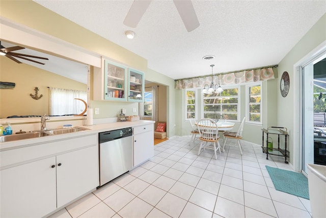 7453 Spinnaker Blvd, Englewood, FL 34224 - kitchen featuring stainless steel dishwasher, a ceiling fan, light countertops, glass insert cabinets, and hanging light fixtures