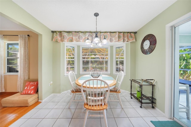 7453 Spinnaker Blvd, Englewood, FL 34224 - dining room with a chandelier and tile patterned flooring