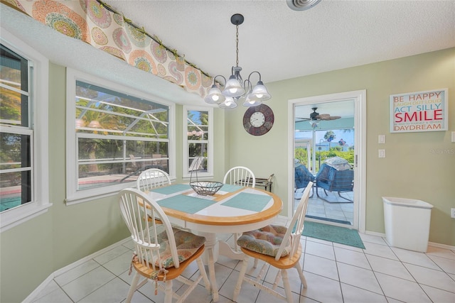 7453 Spinnaker Blvd, Englewood, FL 34224 - dining area with light tile patterned flooring, a sunroom, a chandelier, a textured ceiling, and ceiling fan