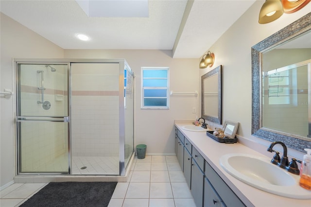 7453 Spinnaker Blvd, Englewood, FL 34224 - bathroom with a shower stall, double vanity, tile patterned flooring, and a textured ceiling