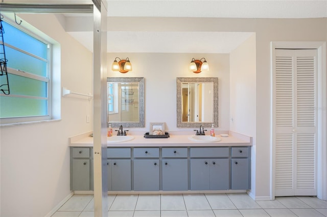 7453 Spinnaker Blvd, Englewood, FL 34224 - bathroom featuring a closet, double vanity, and tile patterned flooring