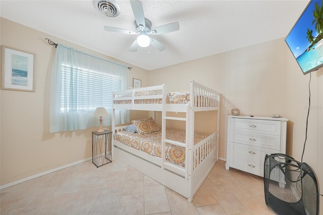 7453 Spinnaker Blvd, Englewood, FL 34224 - bedroom with a textured ceiling, light tile patterned flooring, and a ceiling fan
