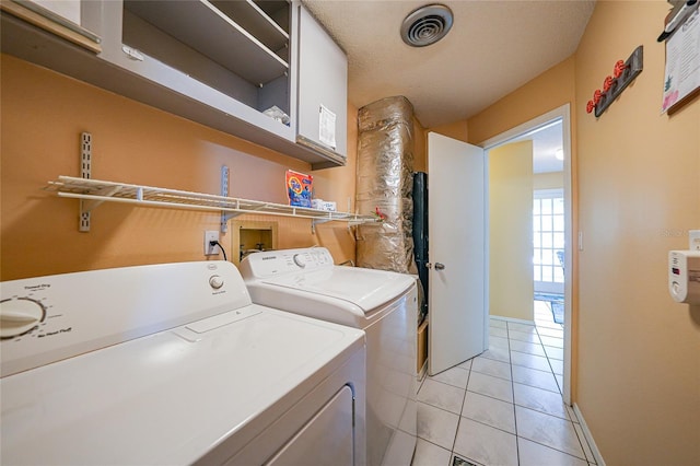 7453 Spinnaker Blvd, Englewood, FL 34224 - laundry room featuring cabinet space, washing machine and clothes dryer, and light tile patterned floors